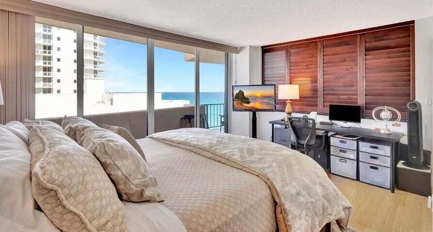 4200 North Ocean Drive, Unit 1905 Singer Island, FL 33404 - Photo 9 of 38 a bedroom with a bed and a large window