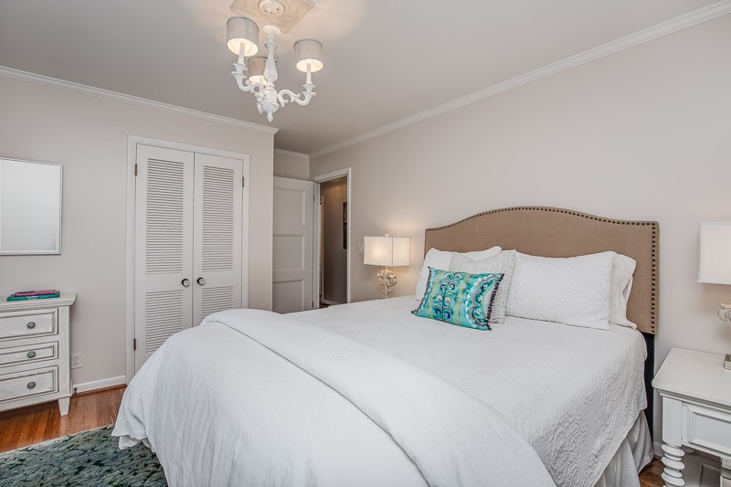 5911 Post Road Nashville, TN 37205 - Photo 18 of 38 a bedroom with a large bed and a chandelier