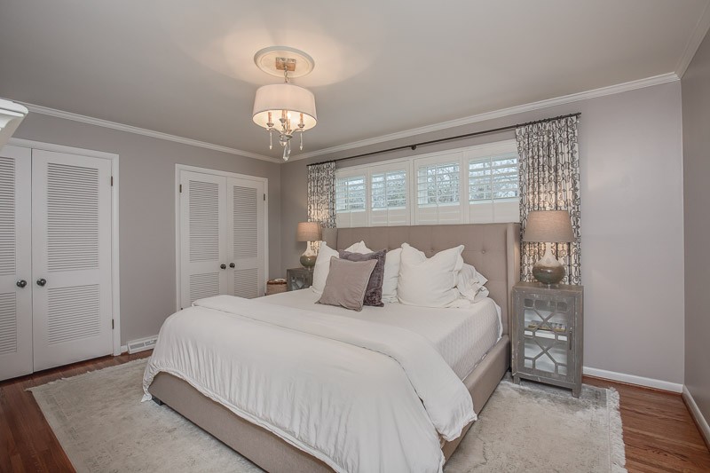 5911 Post Road Nashville, TN 37205 - Photo 19 of 38 a bedroom with a large bed and a chandelier
