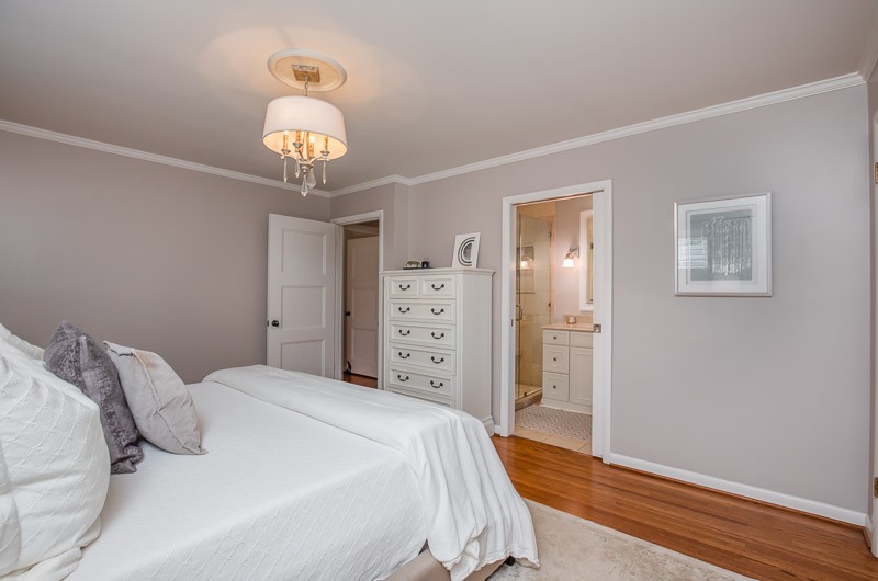 5911 Post Road Nashville, TN 37205 - Photo 20 of 38 a bedroom with a bed and a chandelier