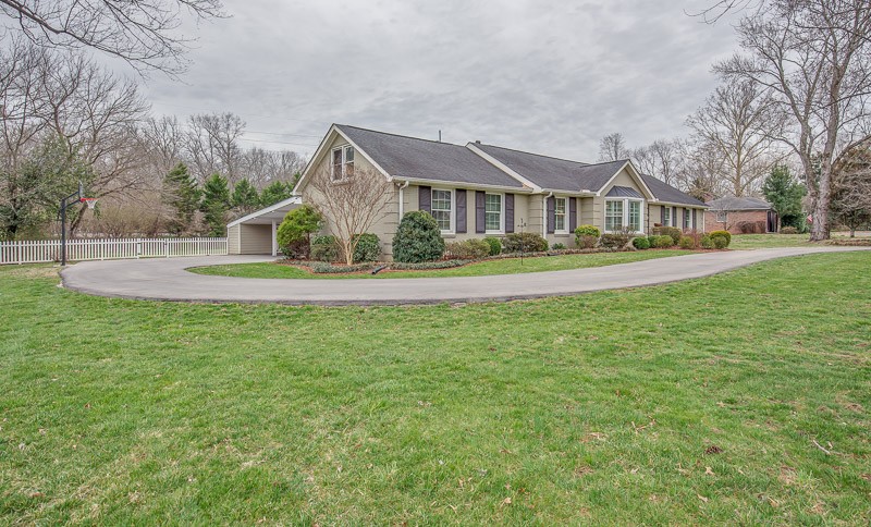 5911 Post Road Nashville, TN 37205 - Photo 2 of 38 a front view of a house with a yard