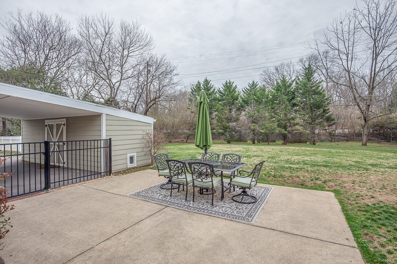 5911 Post Road Nashville, TN 37205 - Photo 37 of 38 a view of a patio with a table chairs and backyard