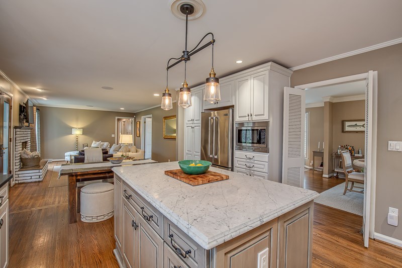 5911 Post Road Nashville, TN 37205 - Photo 9 of 38 a kitchen with kitchen island a sink stove and wooden floor