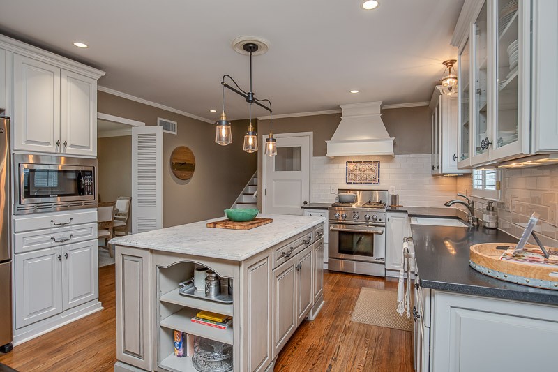 5911 Post Road Nashville, TN 37205 - Photo 10 of 38 a kitchen that has a lot of cabinets in it and wooden floors