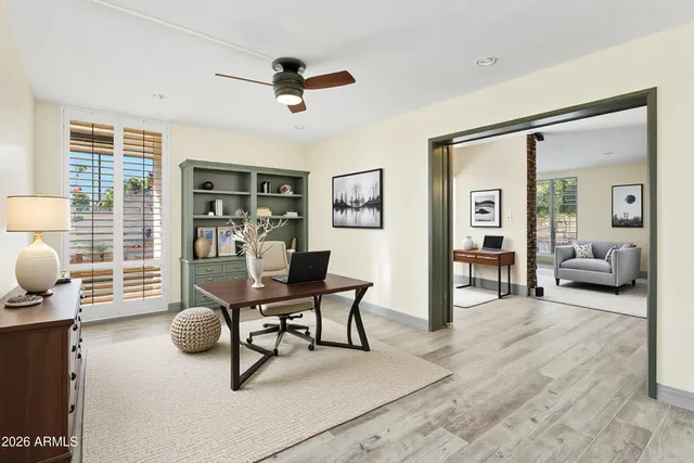 a view of empty room with wooden floor and fireplace