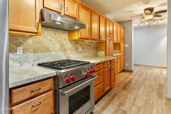 a kitchen with wooden cabinets and a stove top oven