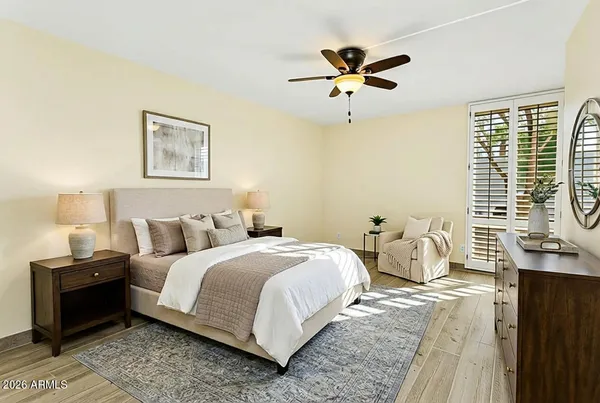 a bedroom with a bed and a chandelier