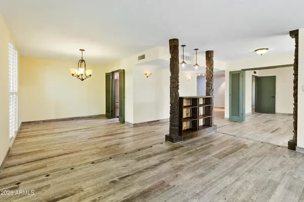 an empty room with wooden floor and closet