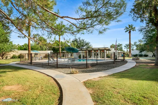 a view of a livingroom with a fireplace a chandelier and wooden floor