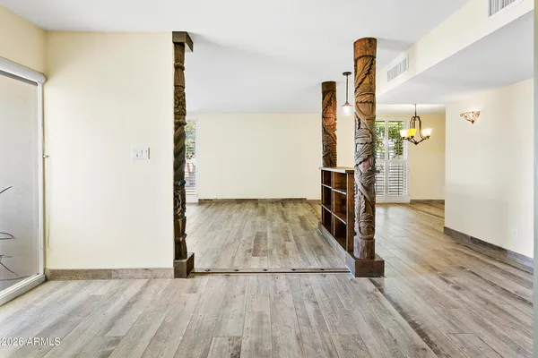 a view of empty room with wooden floor
