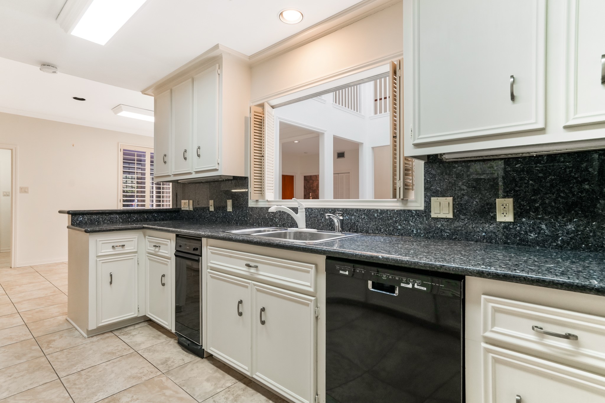 201 Vanderpool Lane, Unit 65 Houston, TX 77024 - Photo 13 of 34 a kitchen with stainless steel appliances granite countertop a sink and a stove