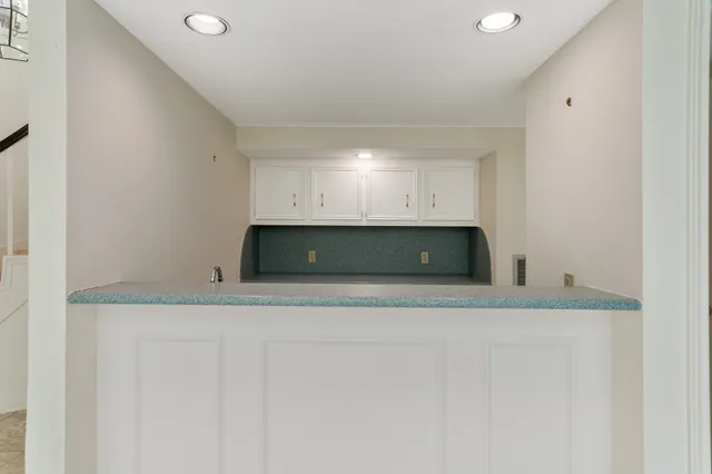 a kitchen with white cabinets and a sink