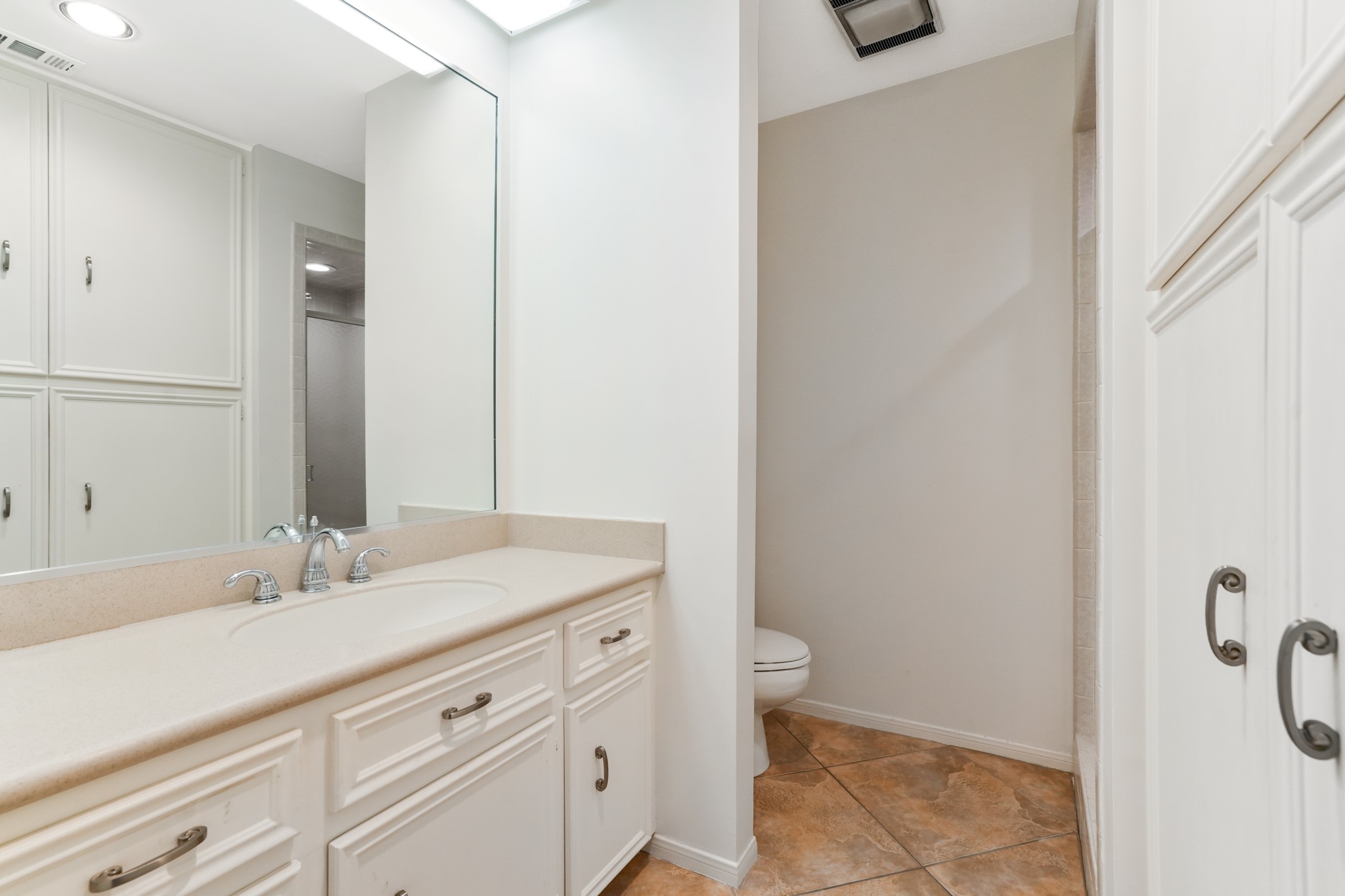 201 Vanderpool Lane, Unit 65 Houston, TX 77024 - Photo 27 of 34 a bathroom with a sink and a mirror