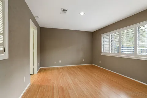 a spacious bathroom with a toilet a sink and a large mirror