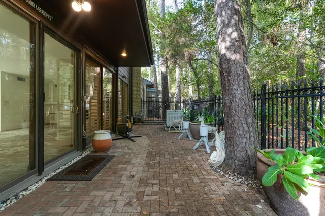 a view of a patio with table and chairs with wooden floor and fence