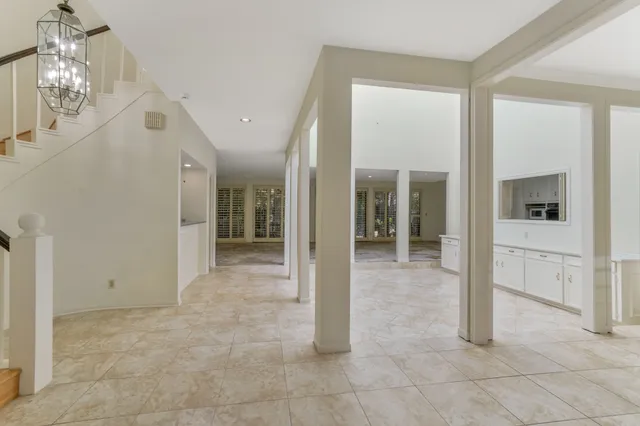 a view of a hallway with chandelier and entryway