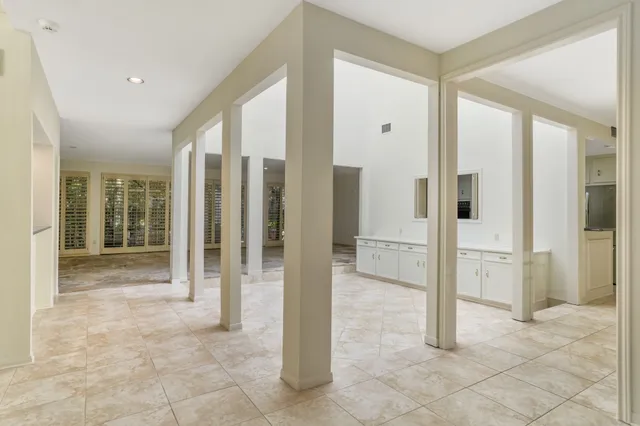 a view of a bathroom with a tub shower and checkered floor