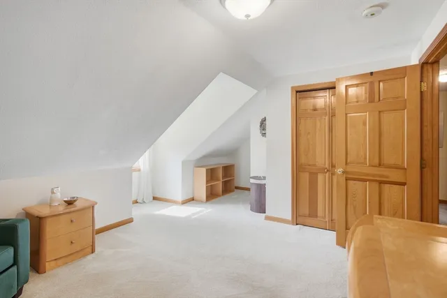 a bathroom with a granite countertop sink a large mirror and a toilet