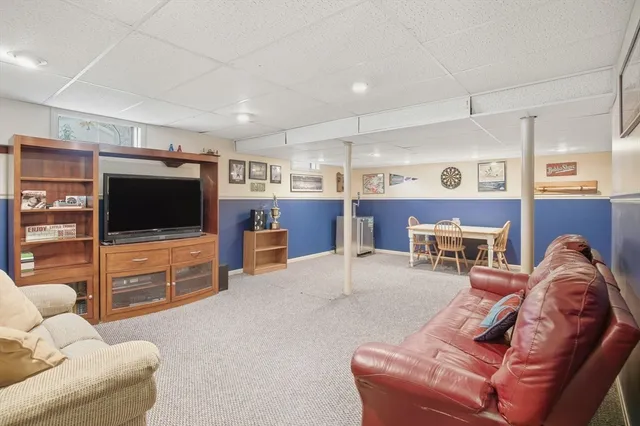 a view of balcony with wooden floor outdoor seating and green space