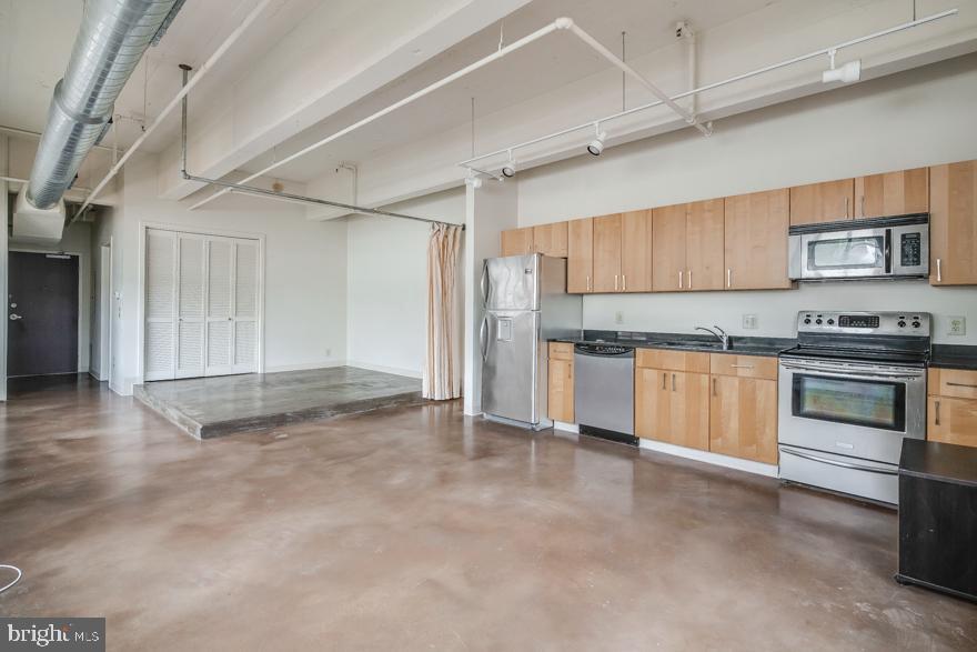 412 South 13th Street, Unit 208 Philadelphia, PA 19147 - Photo 2 of 10 a kitchen with stainless steel appliances granite countertop a stove and a refrigerator