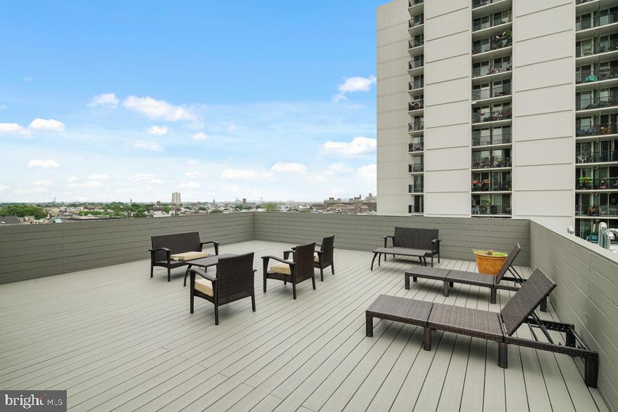 412 South 13th Street, Unit 208 Philadelphia, PA 19147 - Photo 6 of 10 a roof deck with outdoor seating and city view