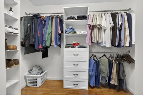 a view of a lake with a yard and large trees