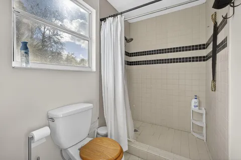 a view of a livingroom with furniture window and wooden floor
