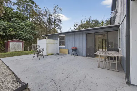 an aerial view of a house with a yard and mountain