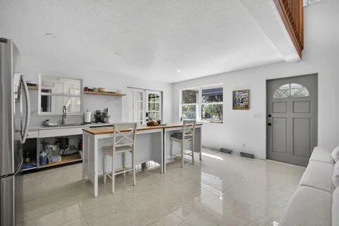 a living room with furniture a dining table and kitchen view
