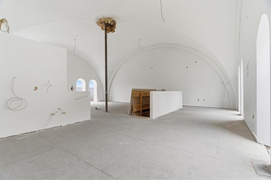 1 Pius Street, Unit A4 Pittsburgh, PA 15203 - Photo 19 of 40 view from kitchen - powder room is behind the wall on the left, stairs to lower level in middle, dining area to right, living room behind pole