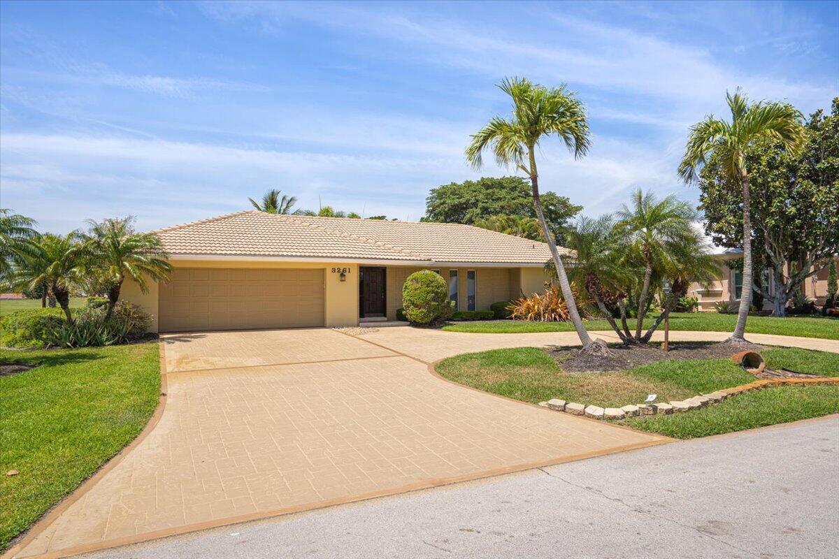 3261 Southeast Fairway West Stuart, FL 34997 - Photo 1 of 44 a front view of a house with garden
