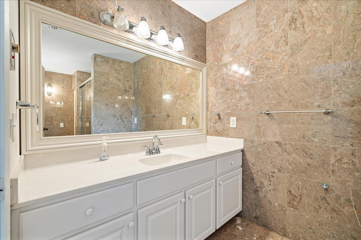 3261 Southeast Fairway West Stuart, FL 34997 - Photo 17 of 44 a bathroom with a sink vanity and mirror