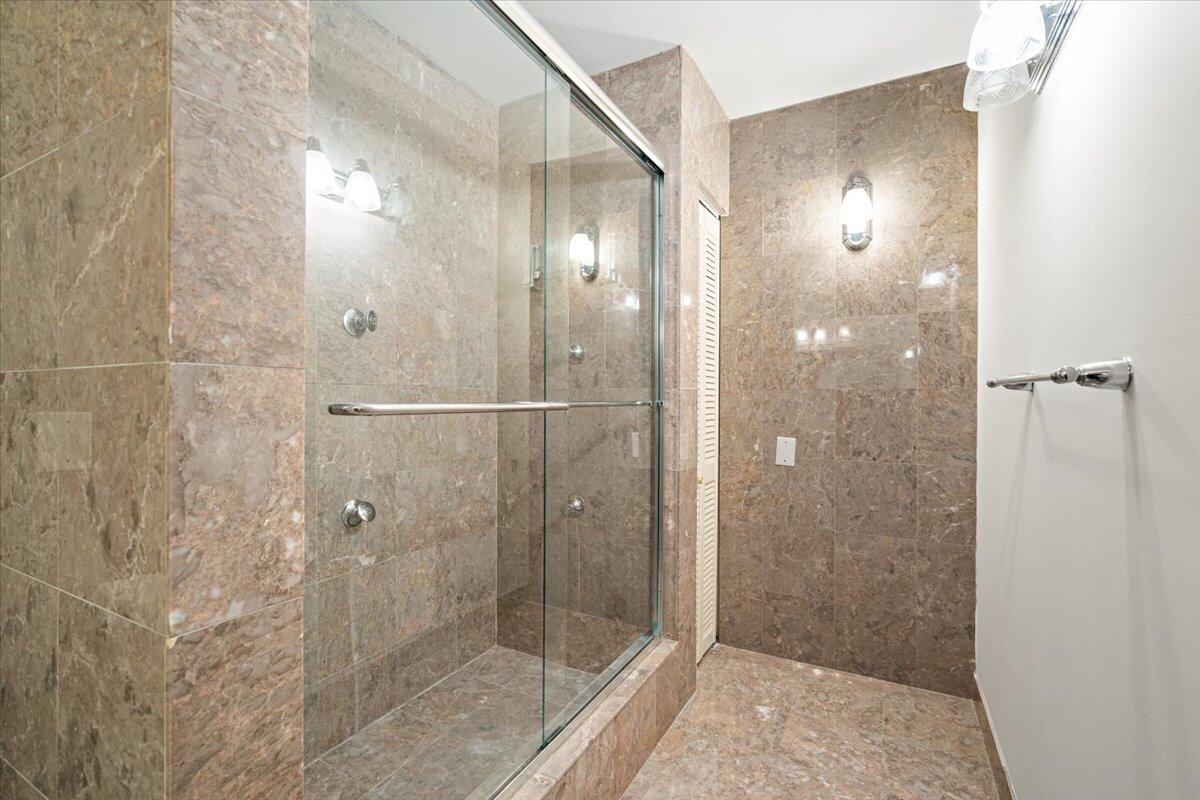 3261 Southeast Fairway West Stuart, FL 34997 - Photo 18 of 44 a bathroom with a glass shower door