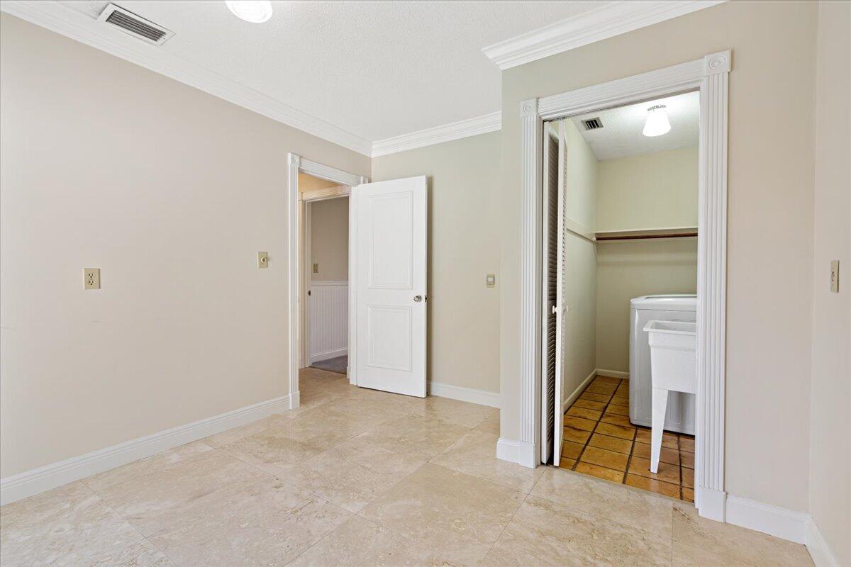 3261 Southeast Fairway West Stuart, FL 34997 - Photo 20 of 44 an empty room with closet and mirror