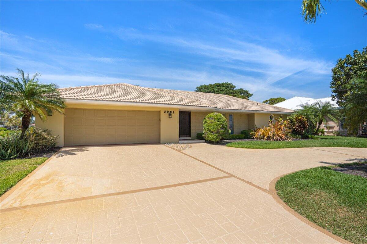 3261 Southeast Fairway West Stuart, FL 34997 - Photo 2 of 44 front view of house with a yard