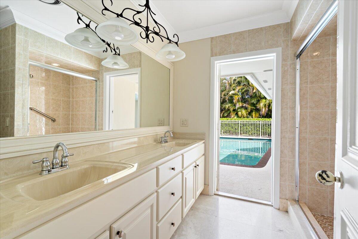 3261 Southeast Fairway West Stuart, FL 34997 - Photo 24 of 44 a bathroom with a sink and a large mirror