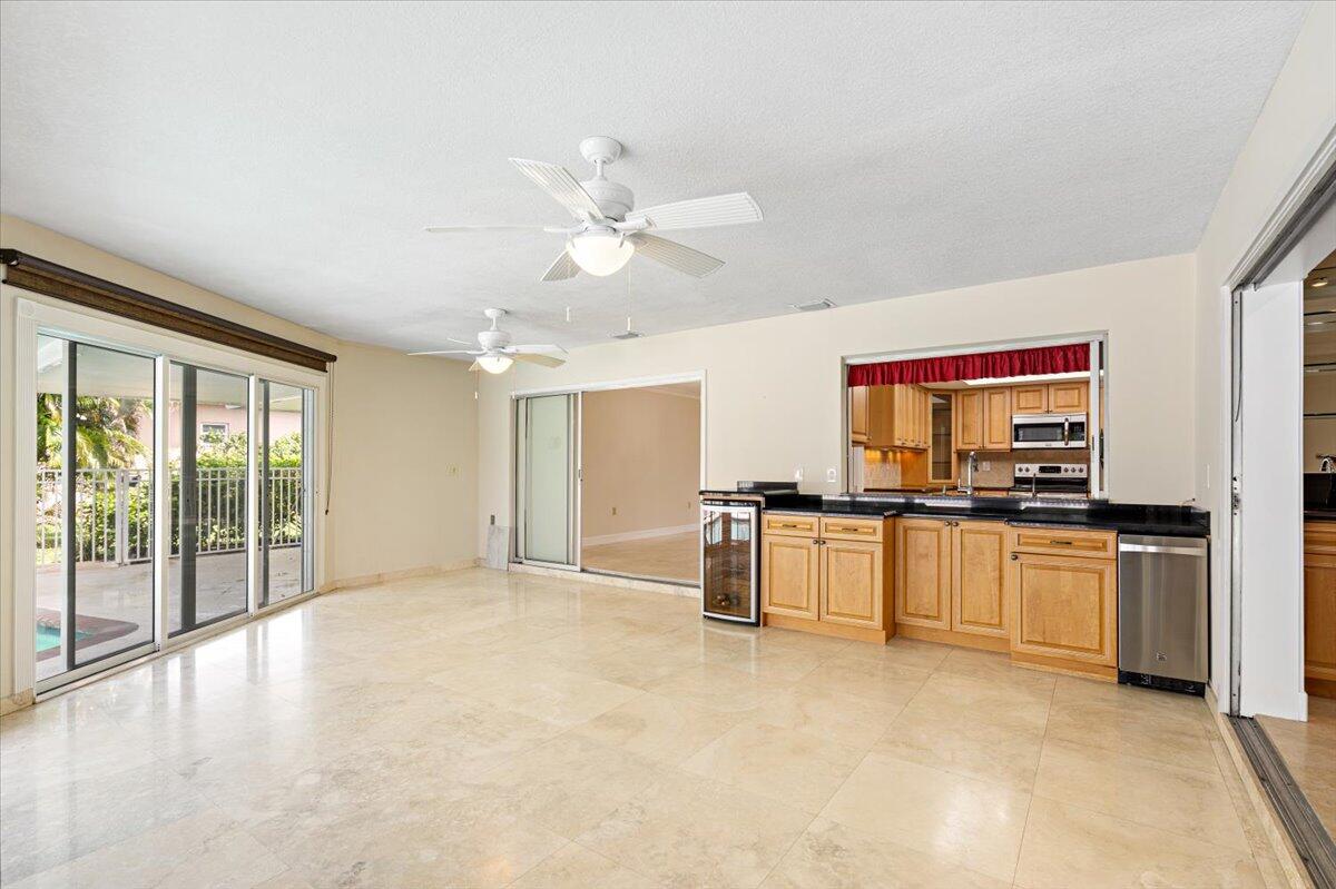 3261 Southeast Fairway West Stuart, FL 34997 - Photo 29 of 44 a view of a kitchen with a sink a refrigerator and window