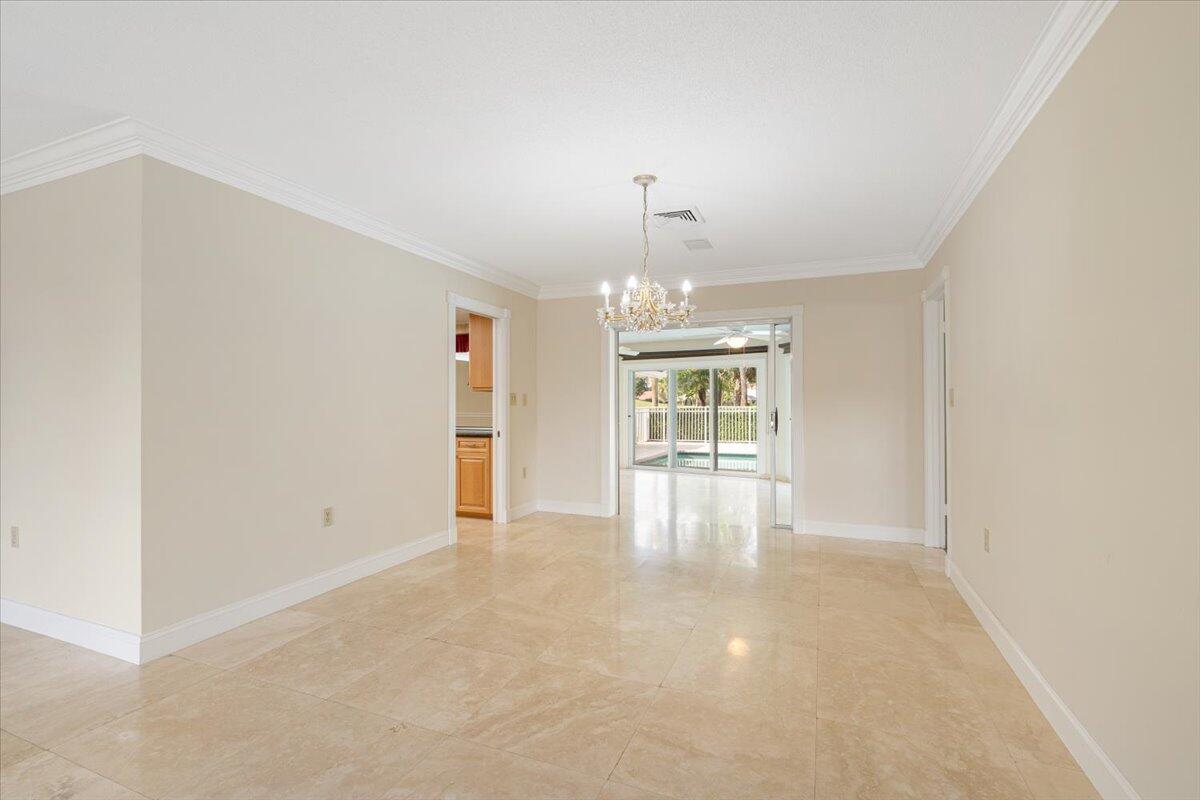 3261 Southeast Fairway West Stuart, FL 34997 - Photo 8 of 44 a view of an empty room with chandelier fan and fire place