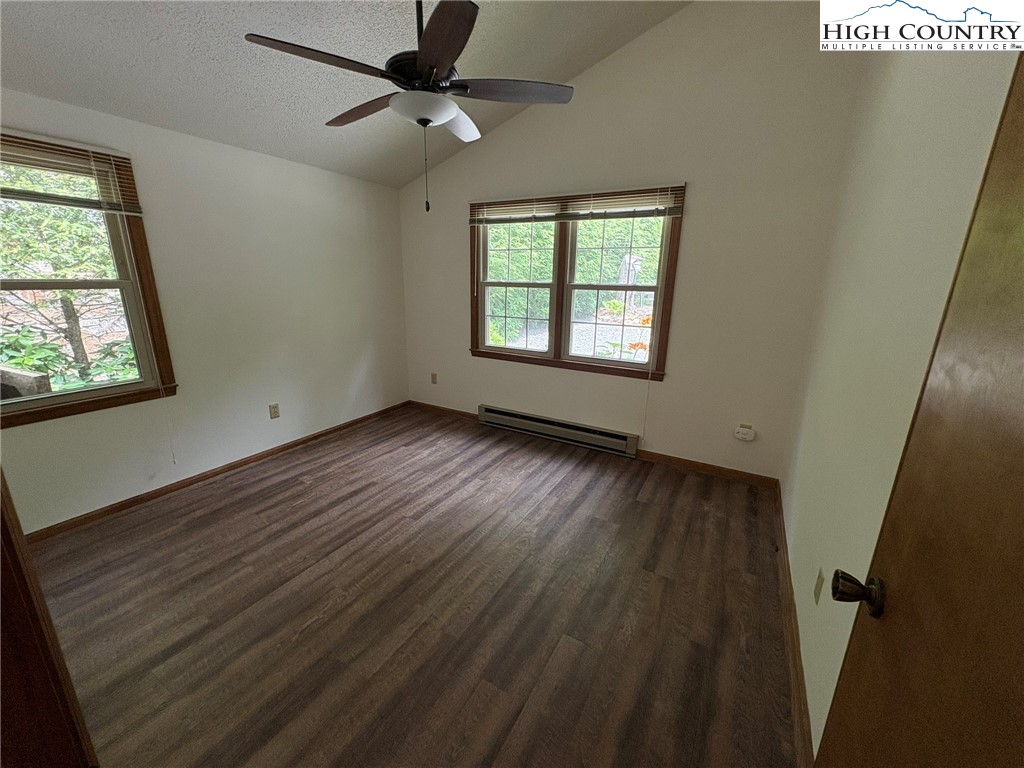 527 Windridge Road Newland, NC 28657 - Photo 12 of 33 a view of an empty room with wooden floor and a window