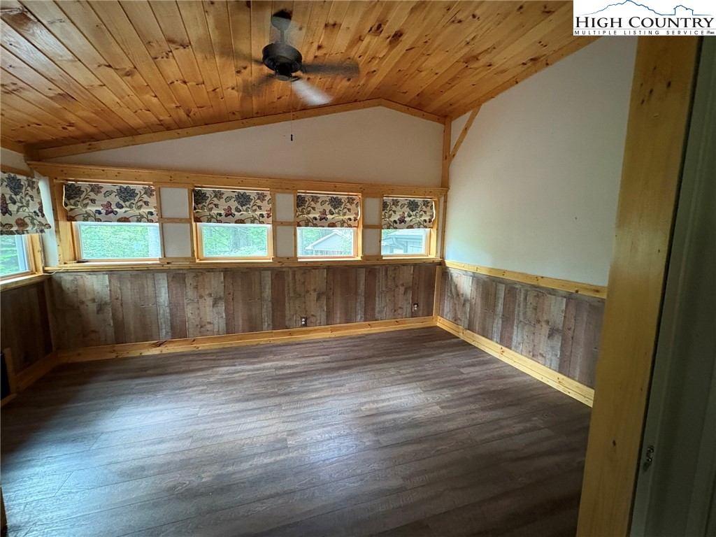 527 Windridge Road Newland, NC 28657 - Photo 19 of 33 en empty room with wooden floor and windows