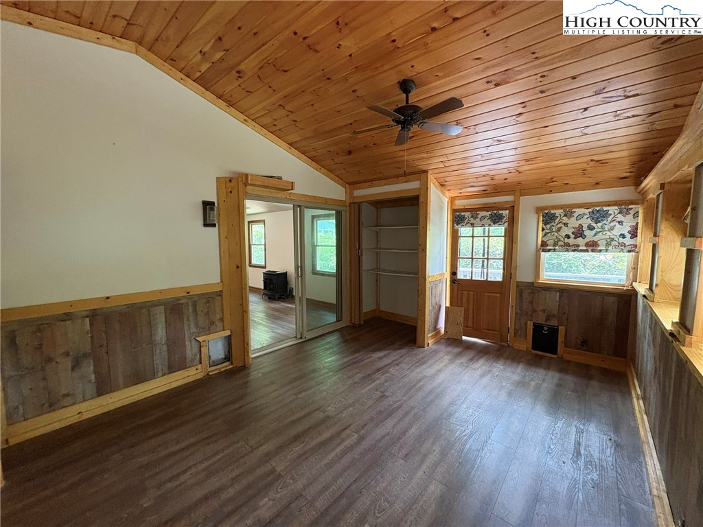 527 Windridge Road Newland, NC 28657 - Photo 21 of 33 a view of an empty room with wooden floor and a window