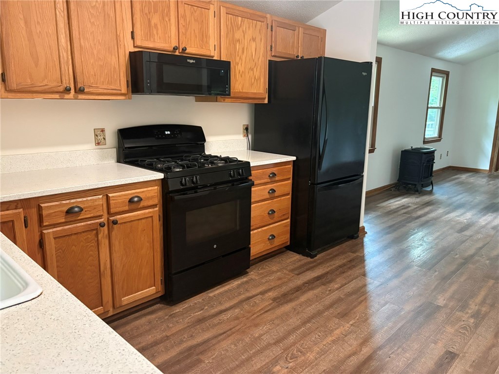 527 Windridge Road Newland, NC 28657 - Photo 6 of 33 a kitchen with stainless steel appliances granite countertop a refrigerator stove and wooden cabinets