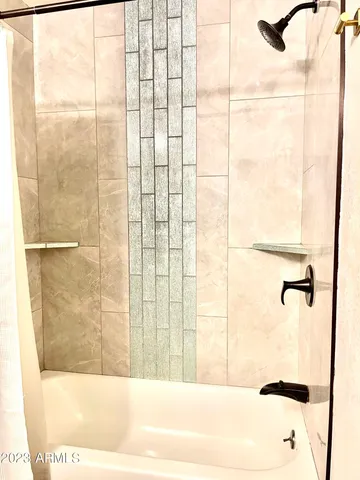 a bathroom with a bathtub and shower