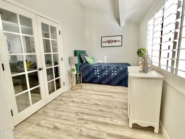 a large bed sitting in a bedroom next to a window