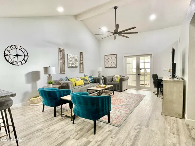 a living room with furniture a rug and a large window