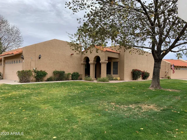 a large tree in front of a house