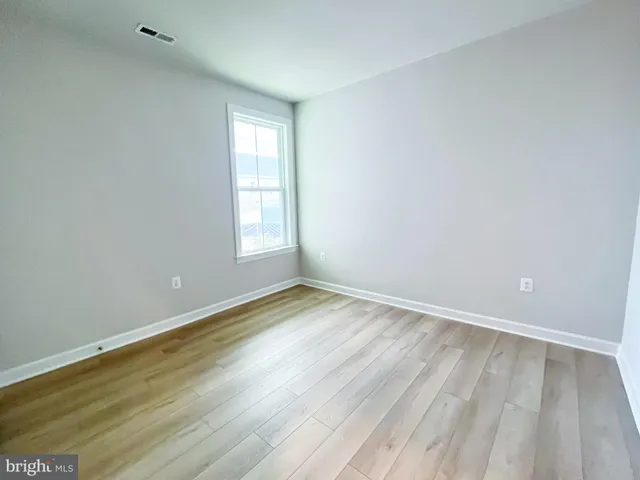 a bathroom with a bathtub shower sink mirror vanity and toilet