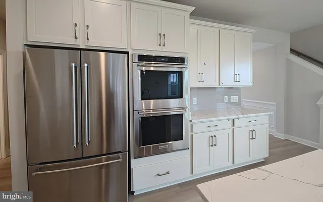a view of kitchen with furniture and wooden floor