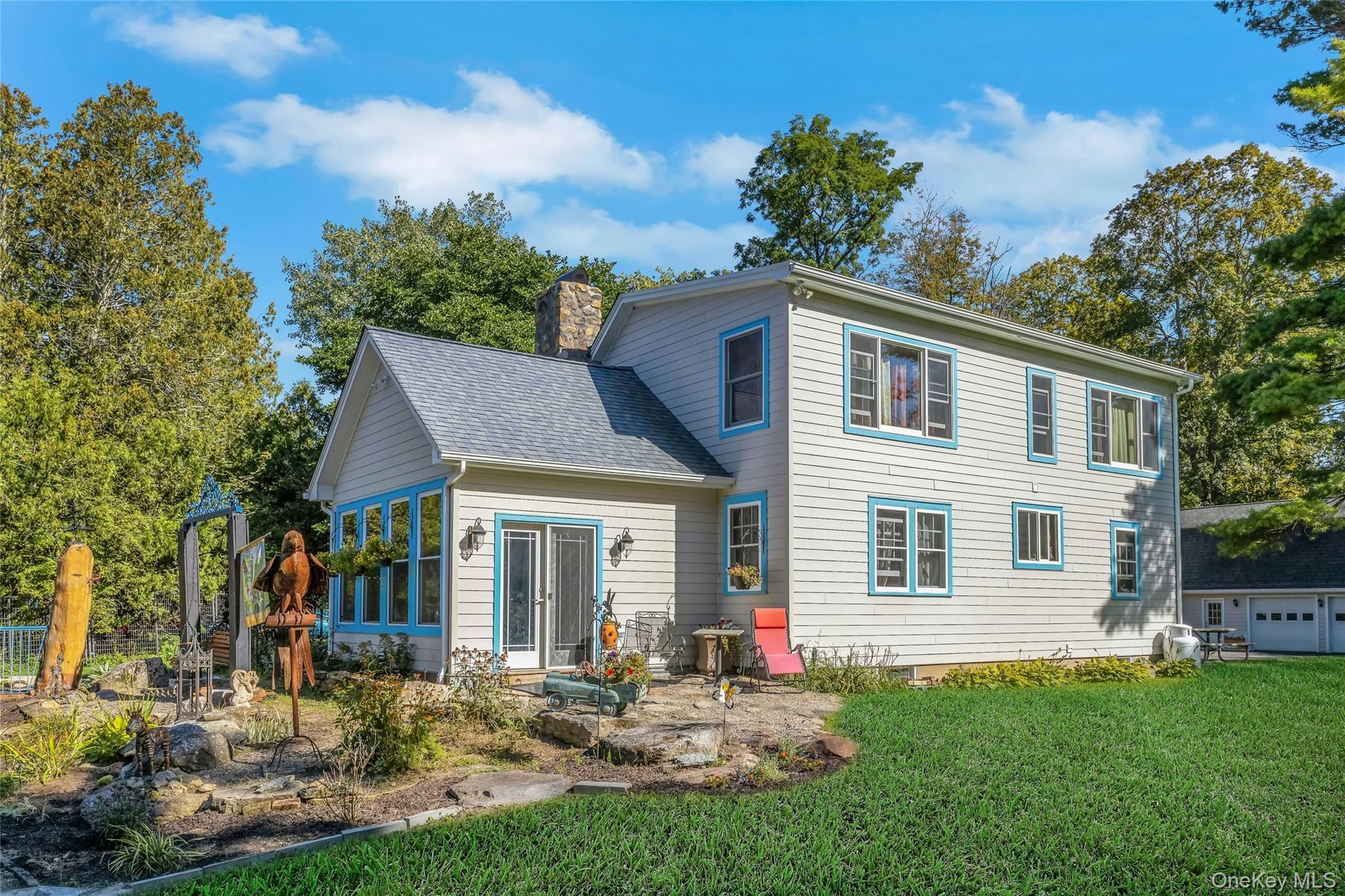 73 Lake Ellis Road Wingdale, NY 12594 - Photo 23 of 41 Rear view of house with a chimney, a patio, a yard, and roof with shingles