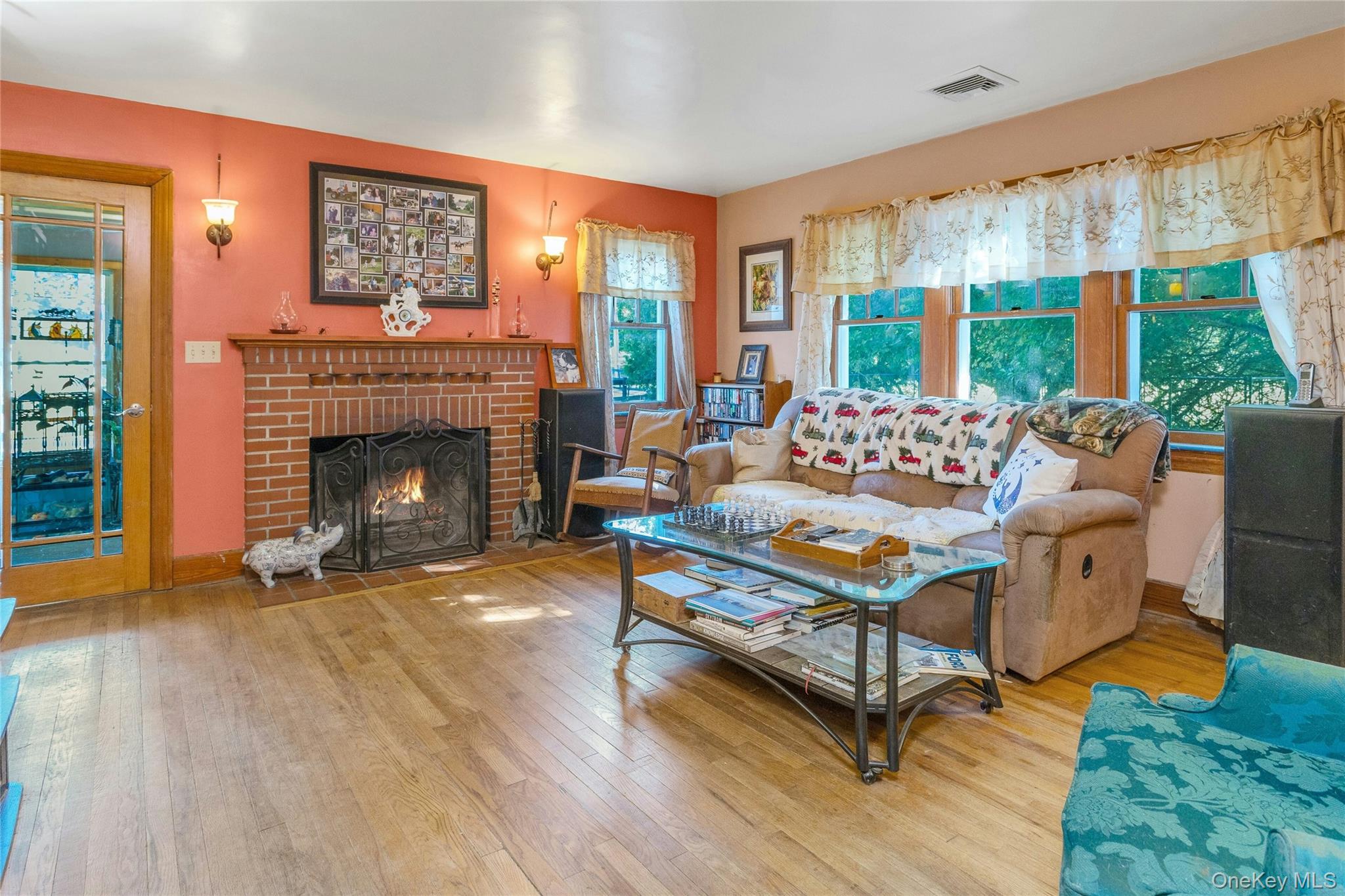 73 Lake Ellis Road Wingdale, NY 12594 - Photo 3 of 41 Living room featuring a brick fireplace and hardwood / wood-style floors